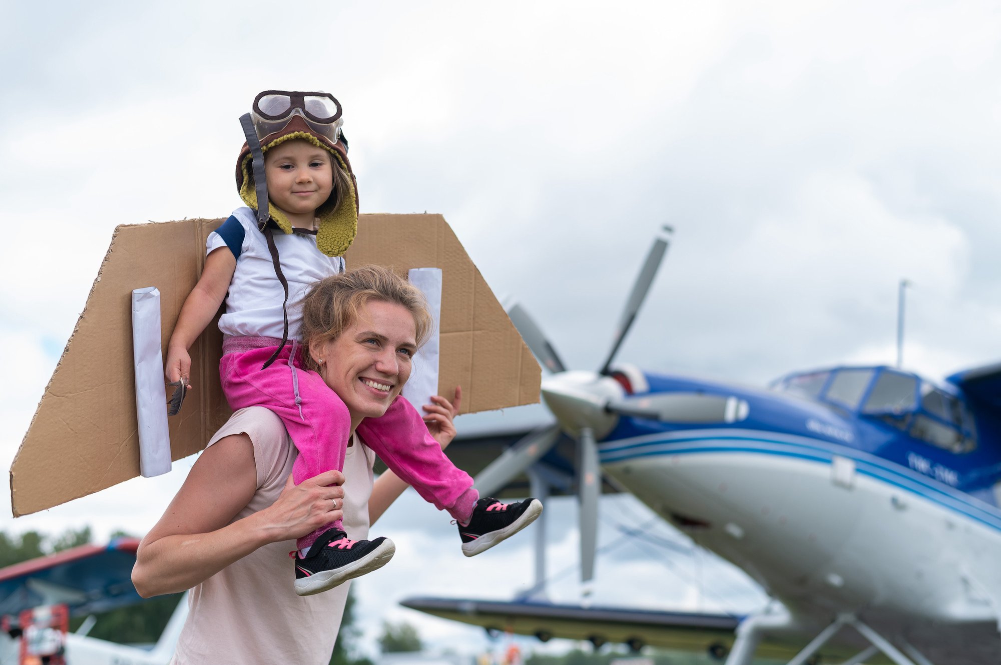 woman with child near small airplane small